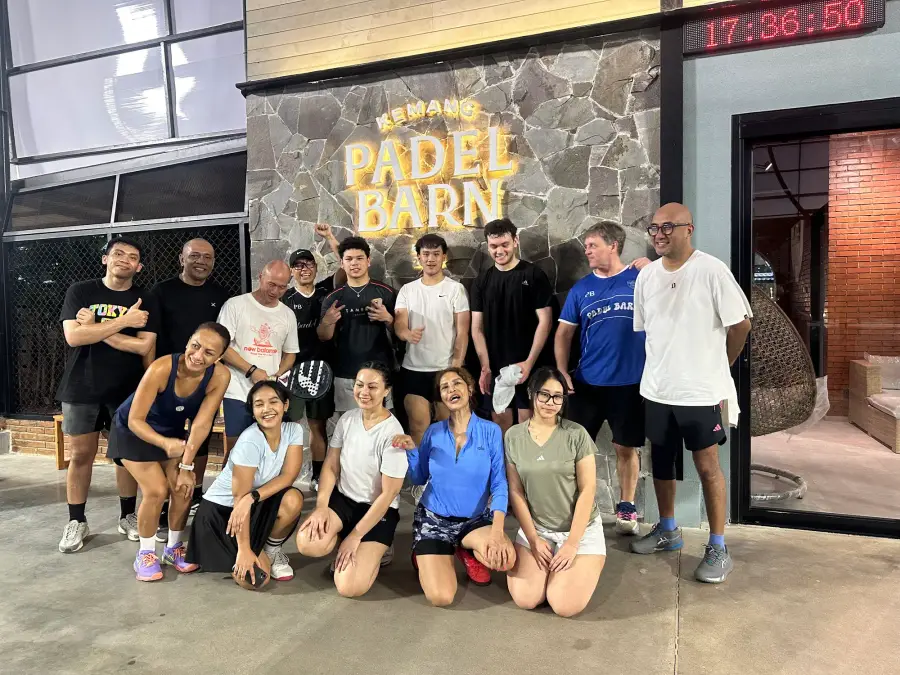 Group photo by the Padel Barn wall