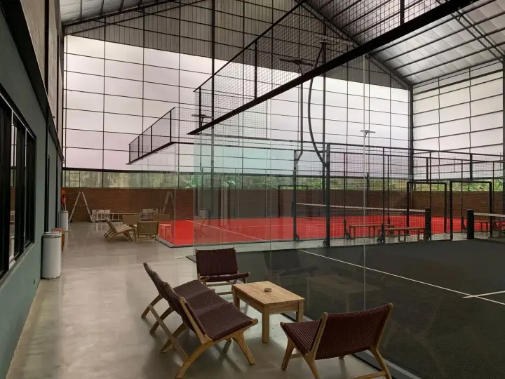 Courtside lounge chairs beside the red court